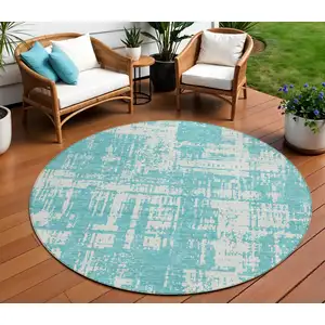 Photo of 8' Aqua And Ivory Round Abstract Washable Indoor Outdoor Area Rug