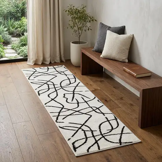 7' Beige And Black Abstract Runner Rug Photo 1