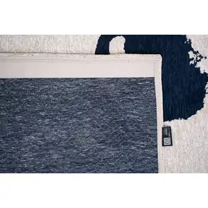 Photo of 8' Beige And Blue Abstract Washable Round Rug With UV Protection