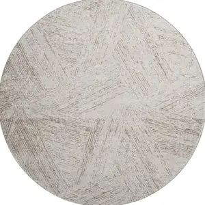 Photo of 8' Beige And Brown Abstract Washable Round Rug With UV Protection