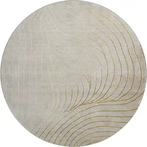 Photo of 8' Beige And Brown Abstract Washable Round Rug With UV Protection