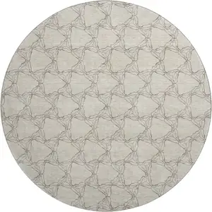 Photo of 8' Beige And Brown Geometric Washable Round Rug With UV Protection