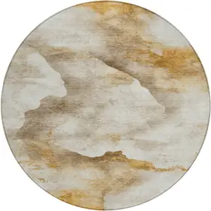 Photo of 8' Beige And Gold Round Abstract Washable Indoor Outdoor Area Rug