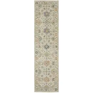 Photo of 10' Beige And Green Wool Oriental Hand Knotted Runner Rug With Fringe