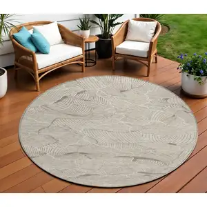 Photo of 8' Beige And Tan Round Abstract Washable Indoor Outdoor Area Rug