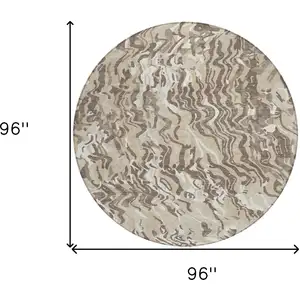 Photo of 8' Beige Brown And Ivory Round Abstract Washable Indoor Outdoor Area Rug