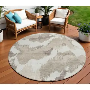 Photo of 8' Beige Brown And Ivory Round Abstract Washable Indoor Outdoor Area Rug