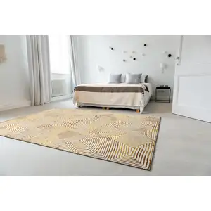 Photo of 5' Beige Gold And Brown Geometric Washable Round Rug With UV Protection