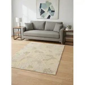 Photo of 8' Beige Gold And Brown Geometric Washable Round Rug With UV Protection