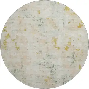 Photo of 8' Beige Gold And Ivory Abstract Washable Round Rug With UV Protection