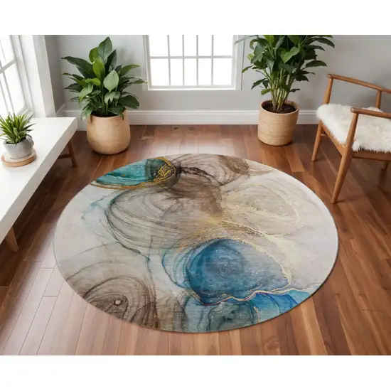 8' Beige Ivory And Blue Abstract Washable Round Rug With UV Protection Photo 2
