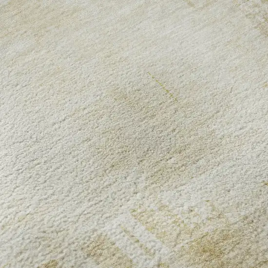 8' Beige Ivory And Gold Abstract Washable Round Rug With UV Protection Photo 8