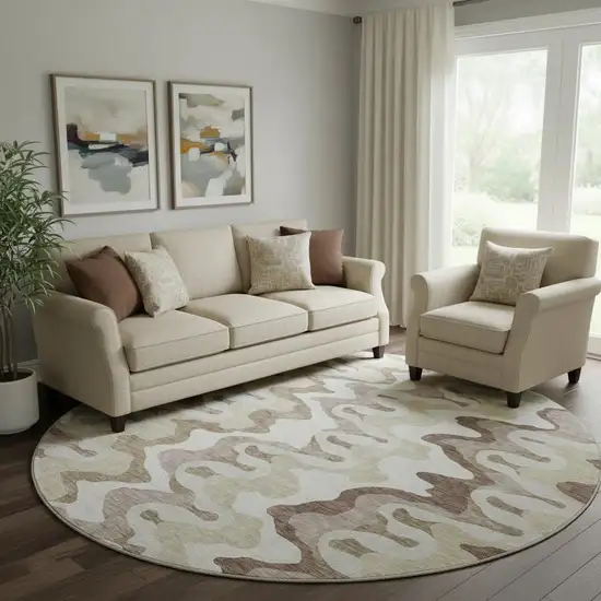 8' Beige Ivory And Taupe Abstract Washable Round Rug With UV Protection Photo 1