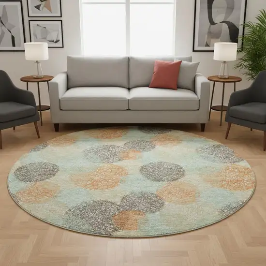 8' Beige Orange And Ivory Abstract Washable Round Rug With UV Protection Photo 2