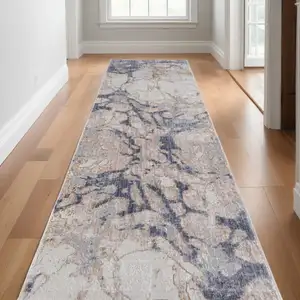 Photo of 12' Beige and Blue Abstract Power Loom Distressed Runner Rug