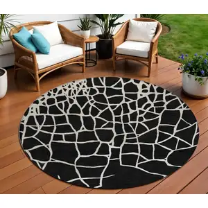 Photo of 8' Black And Beige Round Abstract Washable Indoor Outdoor Area Rug