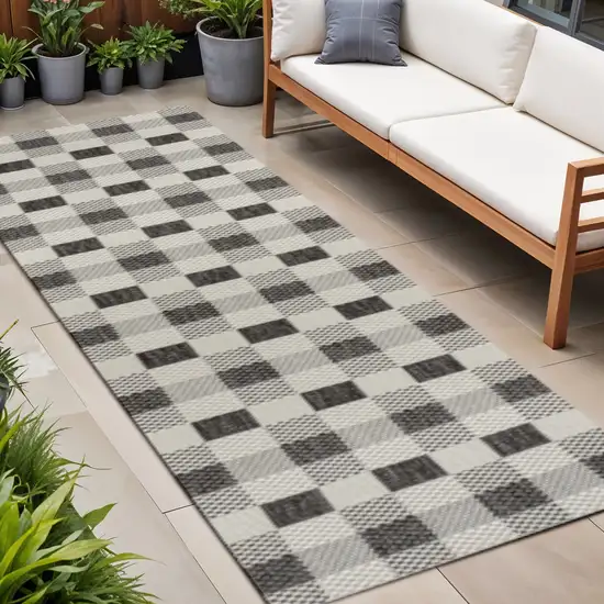8' Black And Cream Geometric Indoor Outdoor Runner Rug Photo 1