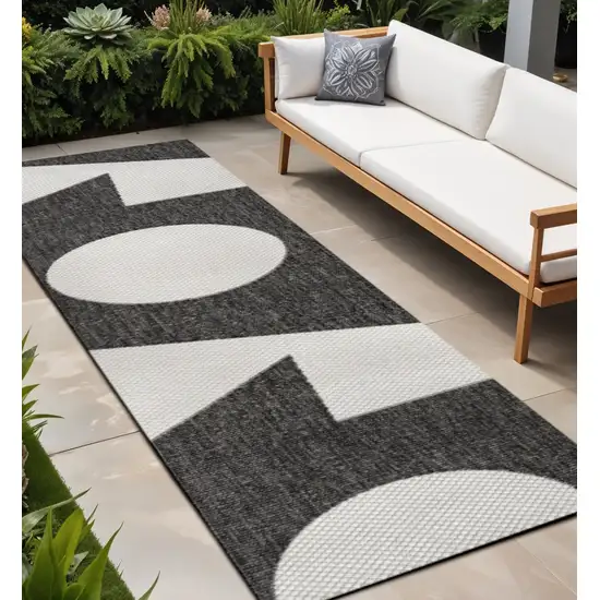 8' Black And Cream Geometric Indoor Outdoor Runner Rug Photo 1
