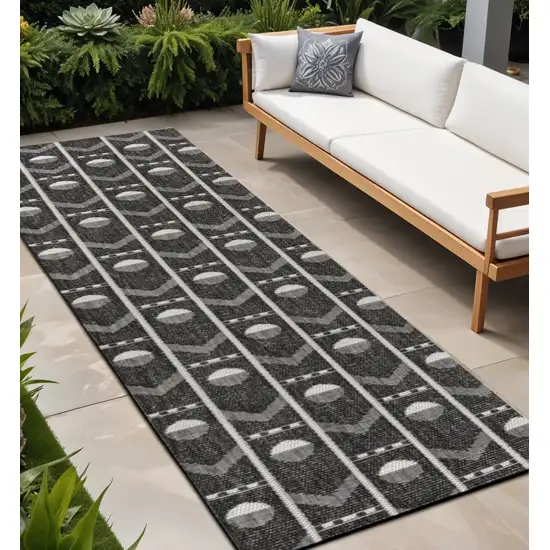 8' Black And Cream Geometric Indoor Outdoor Runner Rug Photo 1