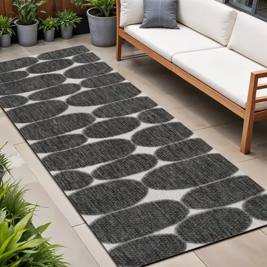 8' Black And Cream Geometric Indoor Outdoor Runner Rug Photo 1