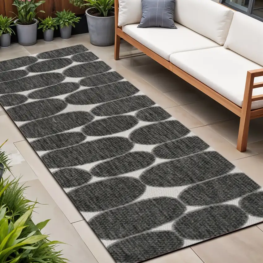 8' Black And Cream Geometric Indoor Outdoor Runner Rug Photo 1