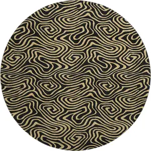 Photo of 8' Black And Gold Abstract Washable Round Rug With UV Protection