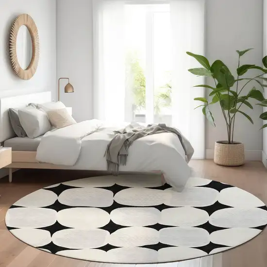 8' Black And Ivory Abstract Geometric Washable Round Rug With UV Protection Photo 5