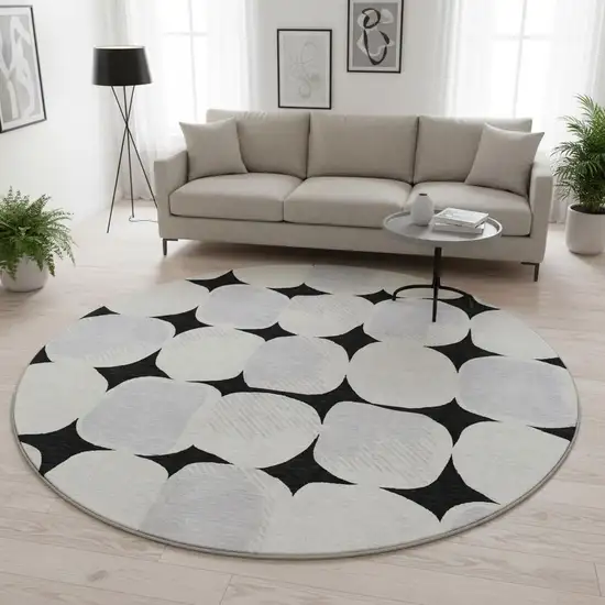 8' Black And Ivory Abstract Geometric Washable Round Rug With UV Protection Photo 2