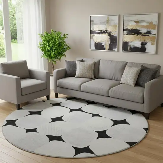 8' Black And Ivory Abstract Geometric Washable Round Rug With UV Protection Photo 1