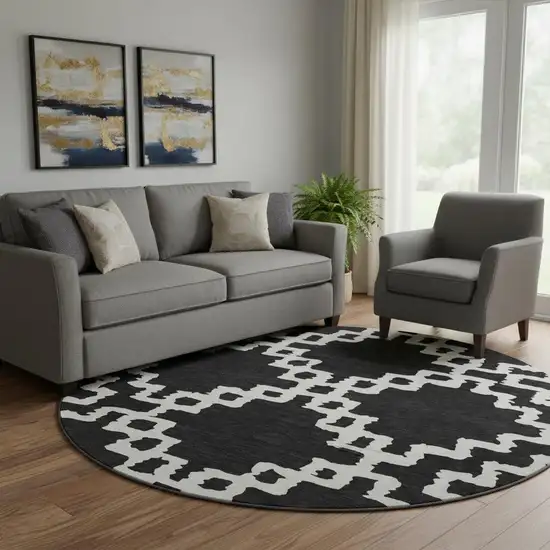 8' Black And Ivory Abstract Geometric Washable Round Rug With UV Protection Photo 1