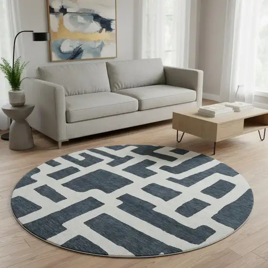8' Black And Ivory Abstract Geometric Washable Round Rug With UV Protection Photo 2