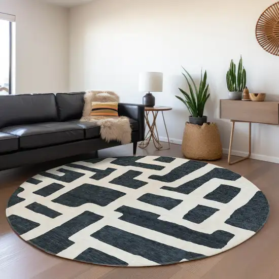 8' Black And Ivory Abstract Geometric Washable Round Rug With UV Protection Photo 4