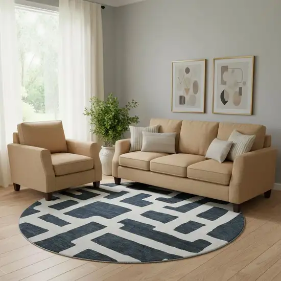 8' Black And Ivory Abstract Geometric Washable Round Rug With UV Protection Photo 1