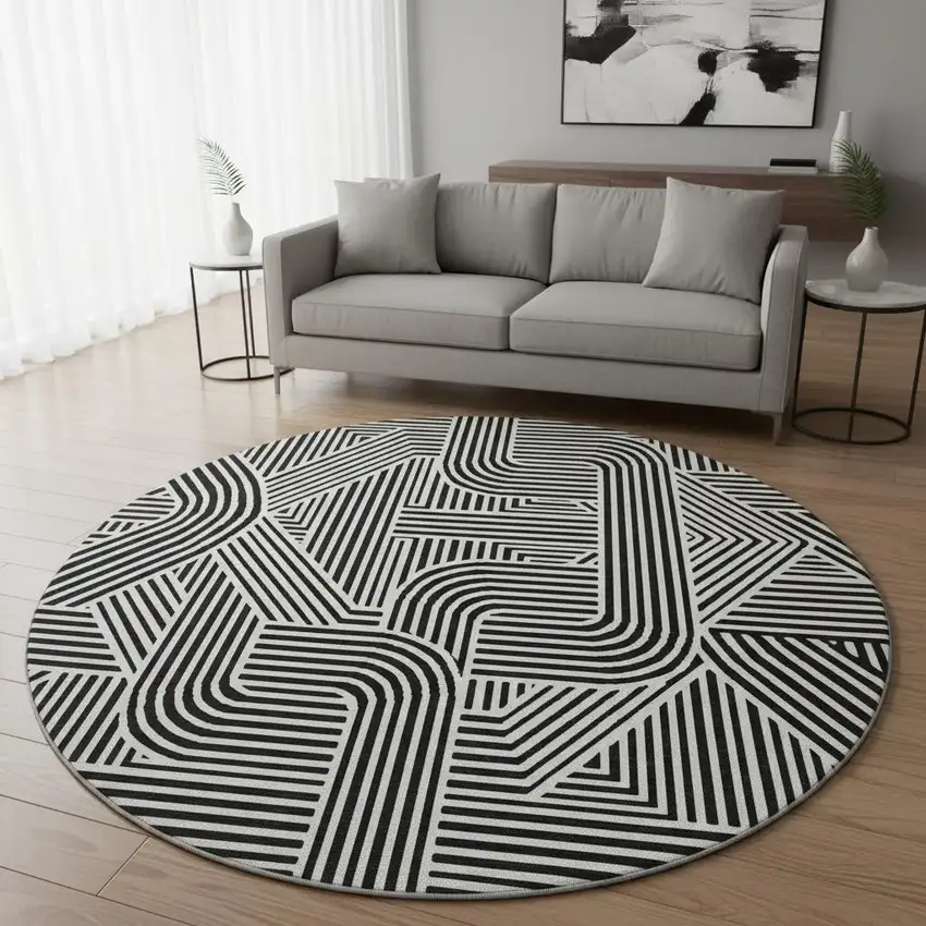 8' Black And Ivory Abstract Geometric Washable Round Rug With UV Protection Photo 2