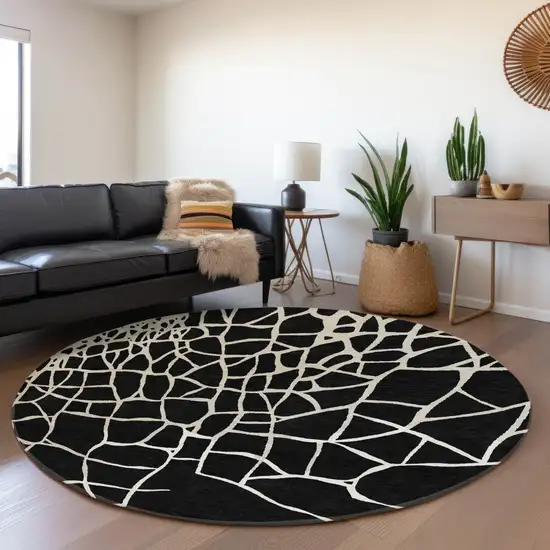 8' Black And Ivory Abstract Geometric Washable Round Rug With UV Protection Photo 5