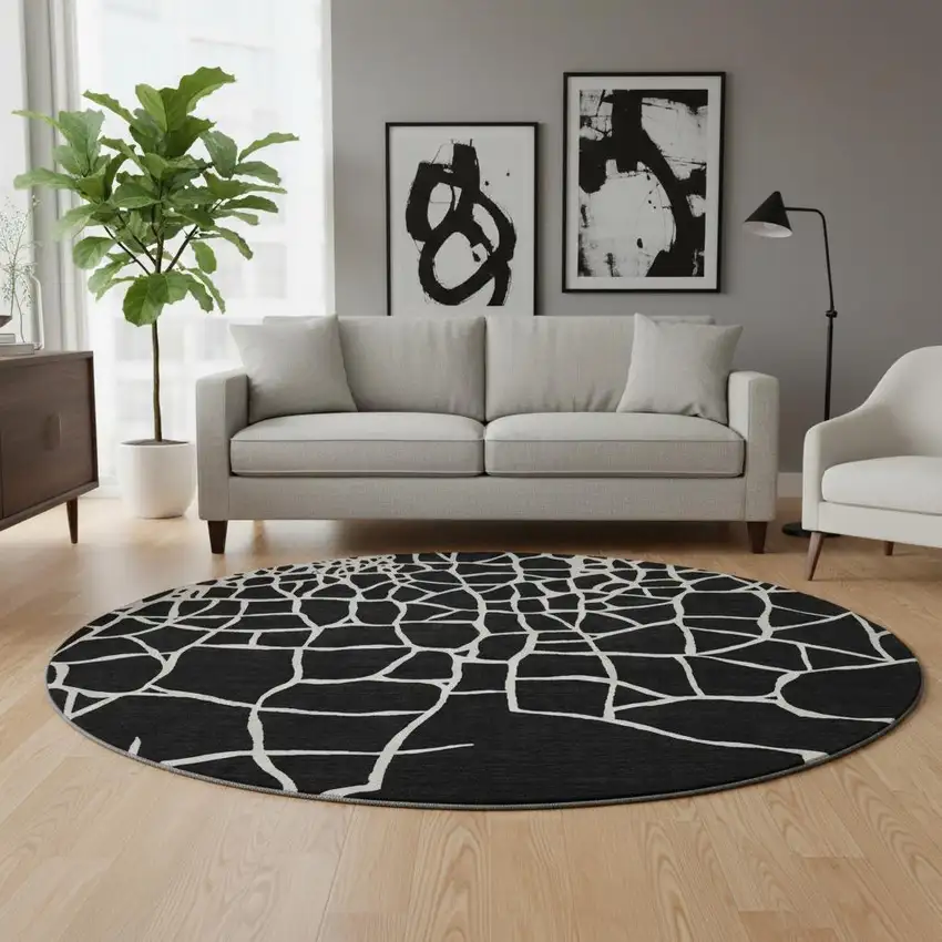 8' Black And Ivory Abstract Geometric Washable Round Rug With UV Protection Photo 2