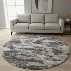 Photo of 8' Black And Ivory Abstract Washable Round Rug With UV Protection