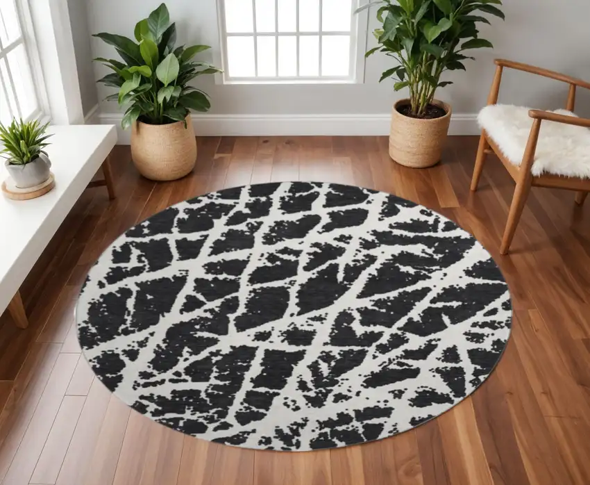8' Black And Ivory Abstract Washable Round Rug With UV Protection Photo 2