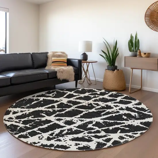 8' Black And Ivory Abstract Washable Round Rug With UV Protection Photo 5