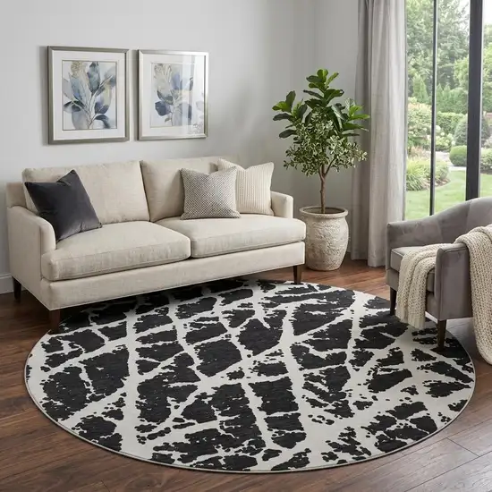 8' Black And Ivory Abstract Washable Round Rug With UV Protection Photo 1