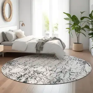 Photo of 8' Black And Ivory Abstract Washable Round Rug With UV Protection