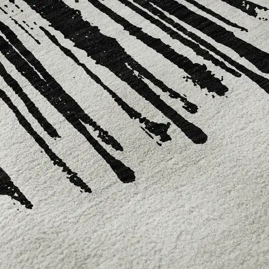 8' Black And Ivory Abstract Washable Round Rug With UV Protection Photo 9