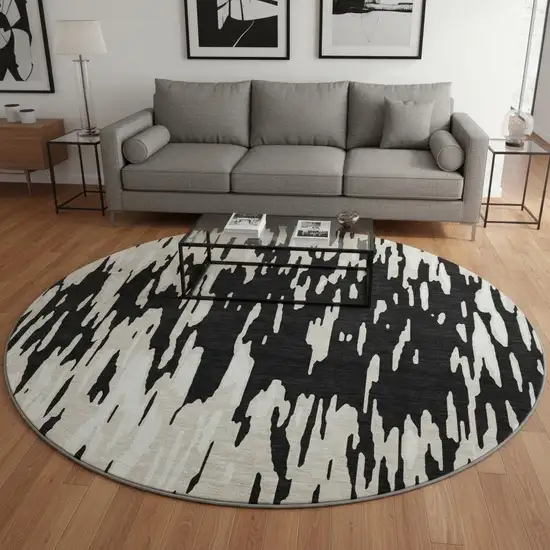 8' Black And Ivory Abstract Washable Round Rug With UV Protection Photo 2