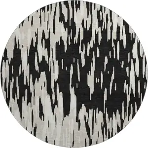 Photo of 8' Black And Ivory Abstract Washable Round Rug With UV Protection