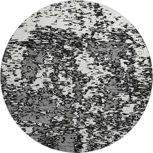 Photo of 8' Black And Ivory Abstract Washable Round Rug With UV Protection