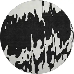 Photo of 8' Black And Ivory Abstract Washable Round Rug With UV Protection