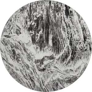 Photo of 8' Black And Ivory Abstract Washable Round Rug With UV Protection