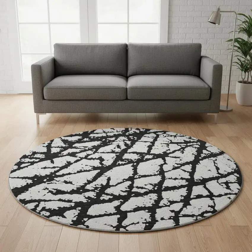 8' Black And Ivory Abstract Washable Round Rug With UV Protection Photo 2