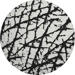 Photo of 8' Black And Ivory Abstract Washable Round Rug With UV Protection