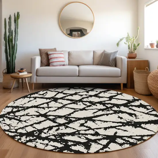 8' Black And Ivory Abstract Washable Round Rug With UV Protection Photo 4